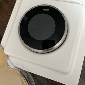 Nest Smart Thermostat in Black and Silver generation two learning thermostat